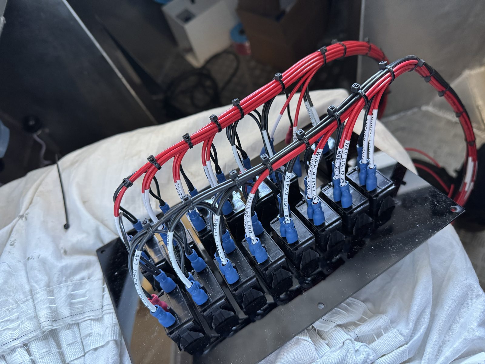 Labelled switch-panel wiring loom with crimped, colour-coded terminals
